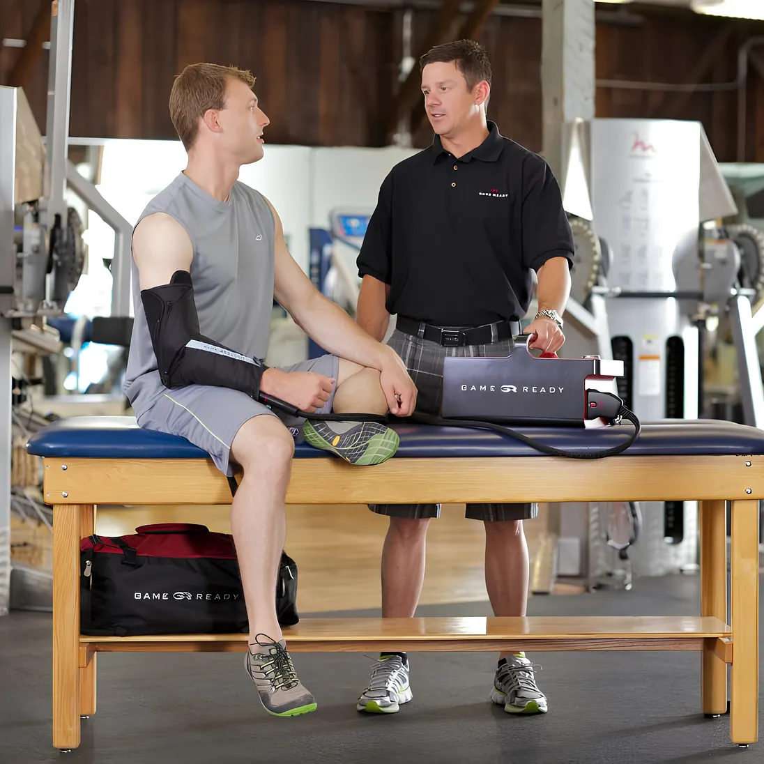 Athlete using a Game Ready GRPro 2.1 with an elbow wrap in a training room