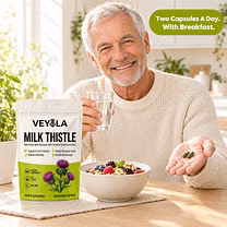 Man taking two Veyola capsules with breakfast